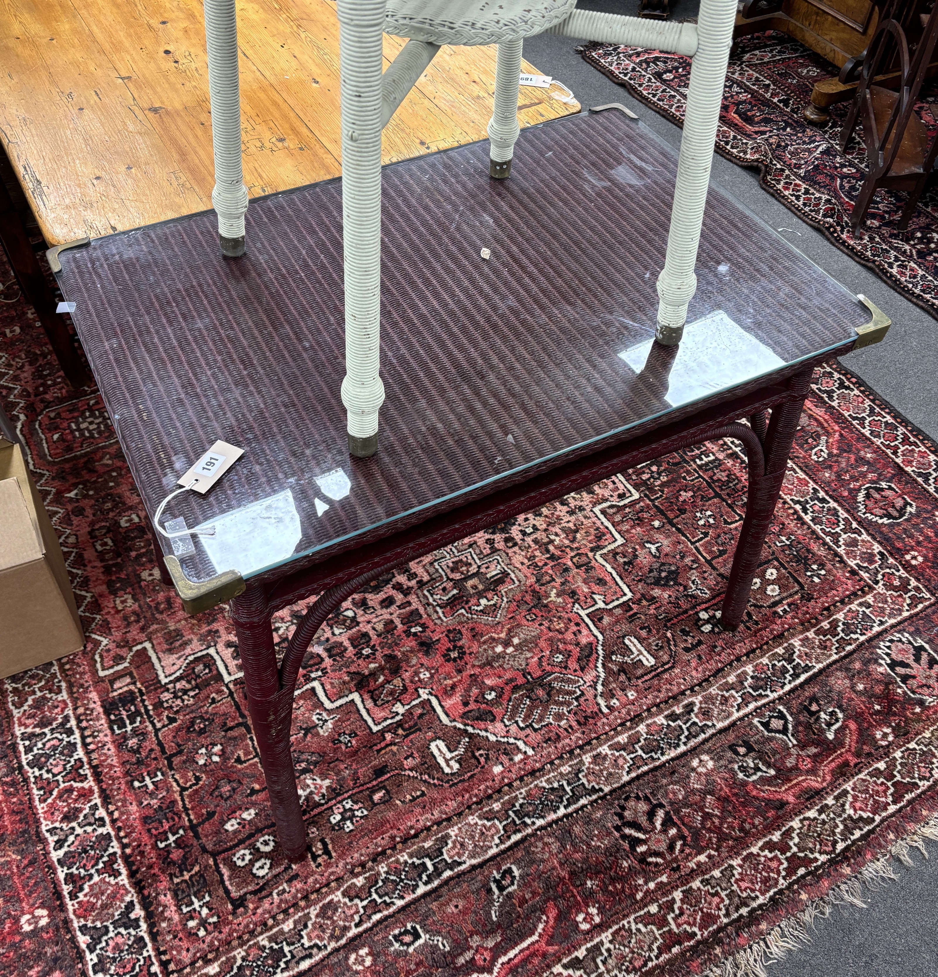 A Lloyd Loom rectangular table, width 91cm, depth 61cm, height 73cm together with a smaller circular Lloyd Loom table